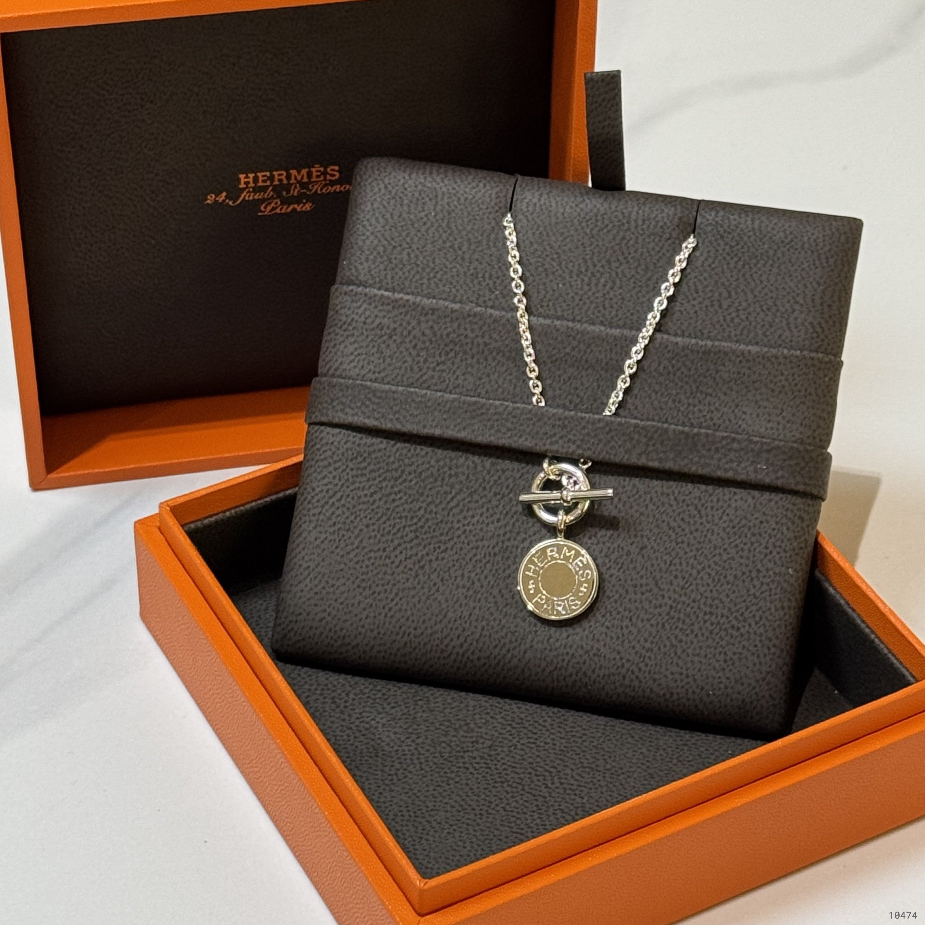 HERMES SILVER BADGE NECKLACE