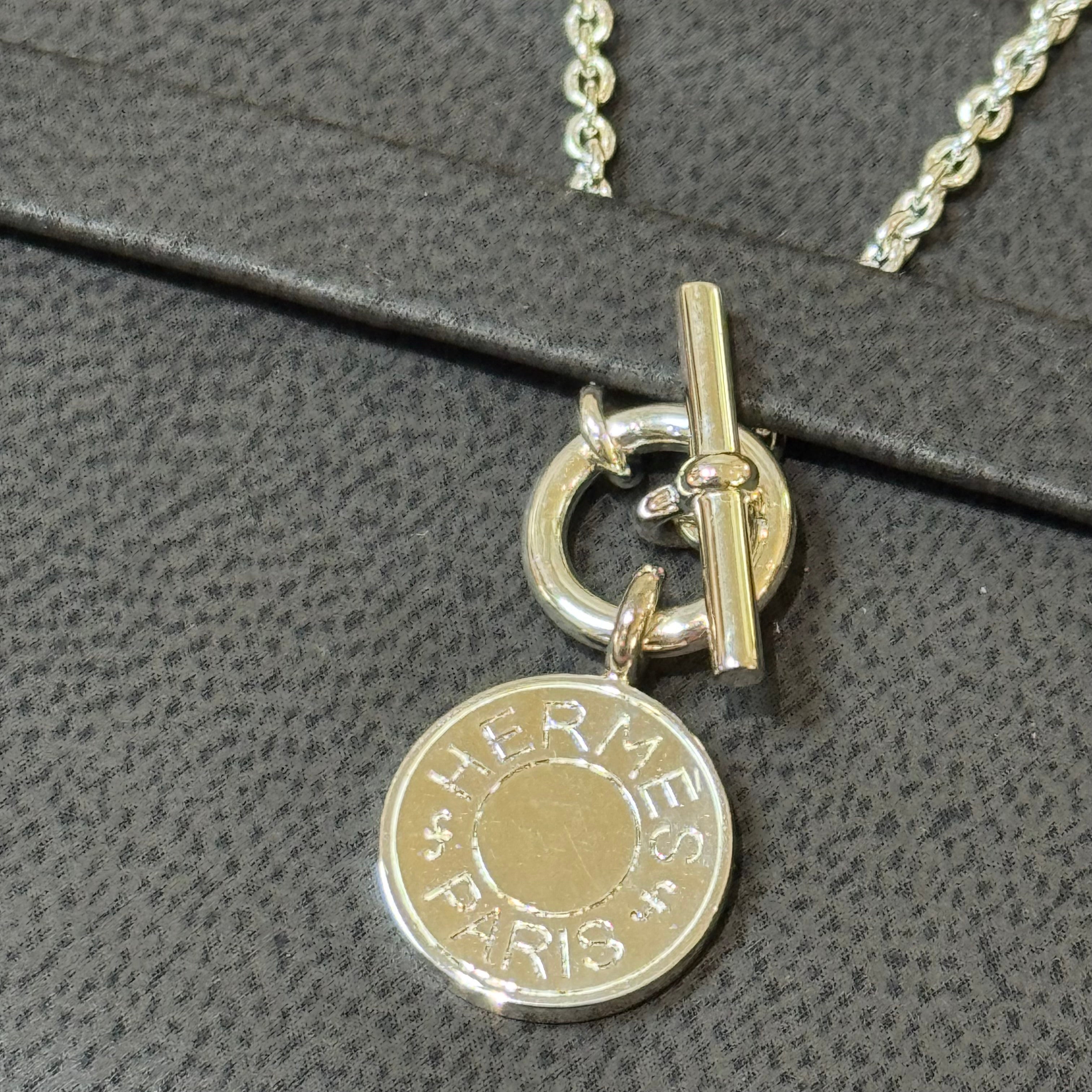 HERMES SILVER BADGE NECKLACE