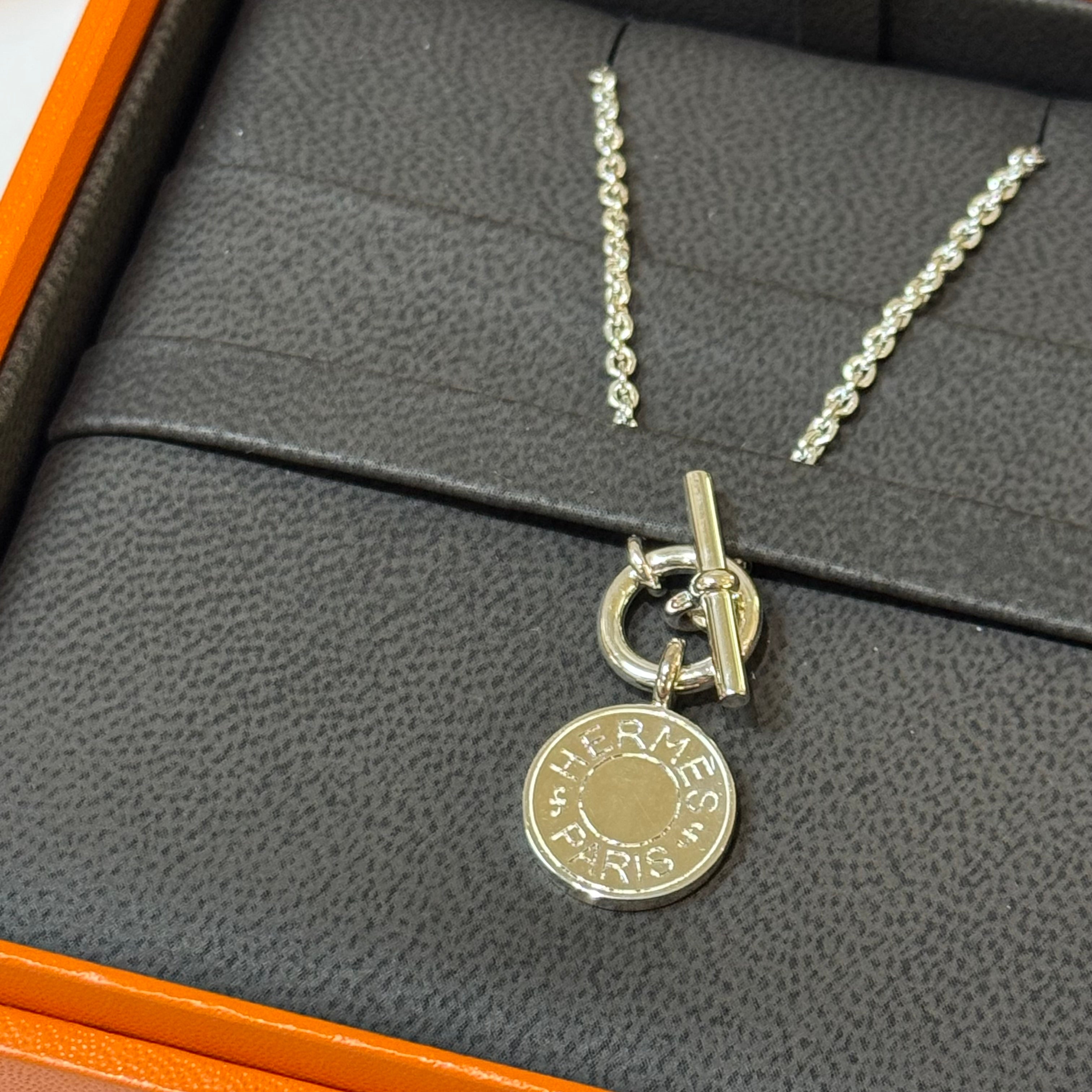 HERMES SILVER BADGE NECKLACE